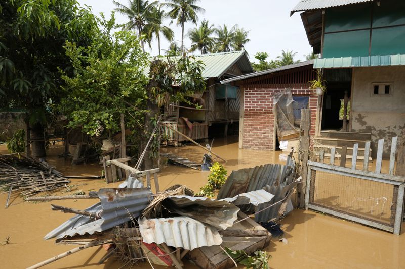 Debris from half-submerged residences floats on a flooded road in Naypyitaw, Myanmar, Saturday, Sept. 14, 2024. (AP Photo/Aung Shine Oo)