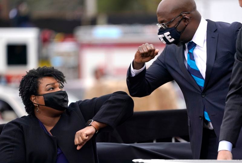 Democratic officials are hopeful that gubernatorial candidate Stacey Abrams and U.S. Sen. Raphael Warnock can bring Blacks to the polls in November despite President Joe Biden's slipping popularity with those voters. (Drew Angerer/Getty Images/TNS)