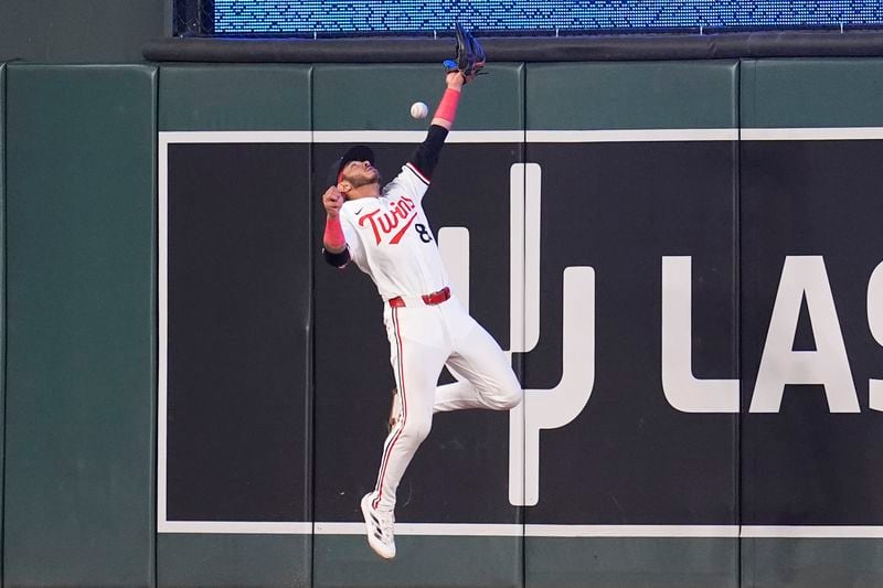 Minnesota Twins center fielder Austin Martin (82) fails to catch a double hit by Atlanta Braves designated hitter Marcell Ozuna during the 10th inning of a baseball game Tuesday, Aug. 27, 2024, in Minneapolis. (AP Photo/Abbie Parr)