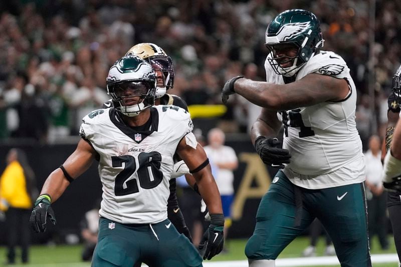 Philadelphia Eagles running back Saquon Barkley (26) celebrates after scoring a two-point conversion against the New Orleans Saints in the second half of an NFL football game in New Orleans, Sunday, Sept. 22, 2024. (AP Photo/Gerald Herbert)