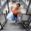 Sofia Roca, a 49-year-old immigrant from Colombia, climbs a stairway inside her apartment complex in Aurora, Colo., on March 29, 2024. (AP Photo/Thomas Peipert)