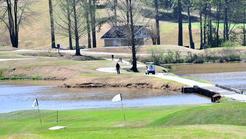 Golfers enjoy the sunny spring weather on the green at Heritage Golf Links in Tucker on Wednesday, March 25, 2020.  (Hyosub Shin / Hyosub.Shin@ajc.com)