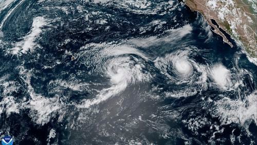 This satellite image provided by the National Oceanic and Atmospheric Administration (NOAA) shows Hurricane Gilma and Tropical Storm Hone, located west-southwest of the southern tip of the Baja California peninsula of Mexico, Thursday, Aug. 22, 2024. (NOAA via AP)