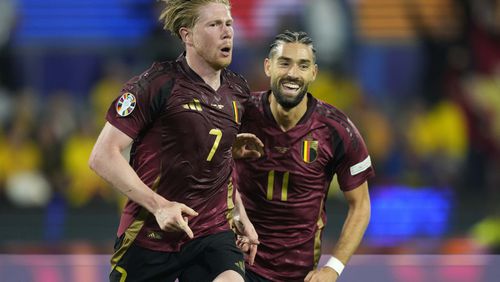 Belgium's Kevin De Bruyne, left, celebrates with Belgium's Yannick Carrasco after scoring his side's second goal during a Group E match between Belgium and Romania at the Euro 2024 soccer tournament in Cologne, Germany, Saturday, June 22, 2024. (AP Photo/Martin Meissner)