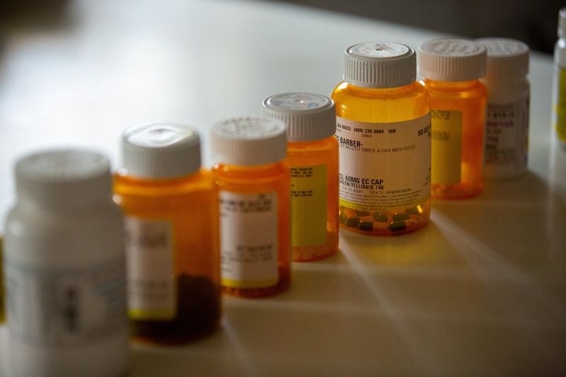 Bruce Barber’s medications sit on his kitchen counter inside his home in Kennesaw. (Photo/Rebecca Wright for the AJC)