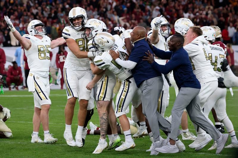 Georgia players celebrate after the NCAA college football game between Georgia Tech and Florida State at the Aviva stadium in Dublin, Saturday, Aug. 24, 2024. (AP Photo/Peter Morrison)