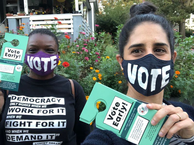 KaeAnne Parris (left) and Clara Totenberg Green canvass to give their neighbors voting resources earlier this year.