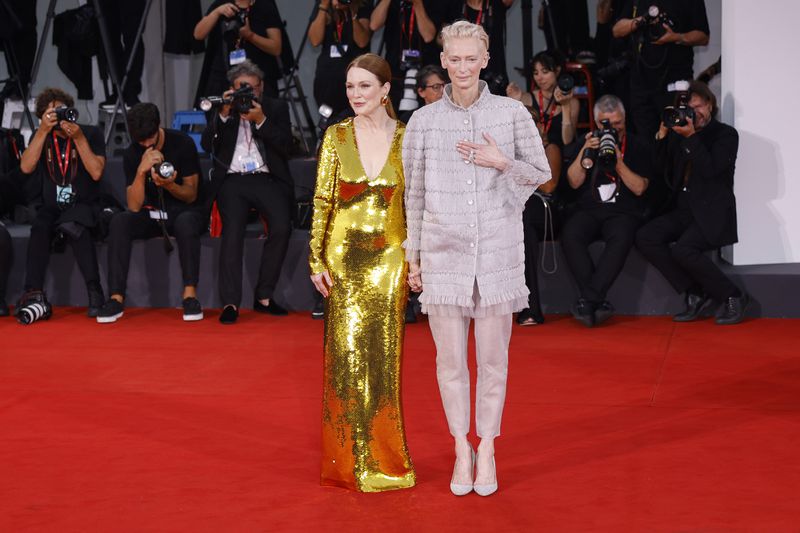 Julianne Moore, left, and Tilda Swinton pose for photographers upon arrival for the premiere of the film 'The Room Next Door' during the 81st edition of the Venice Film Festival in Venice, Italy, on Monday, Sept. 2, 2024. (Photo by Vianney Le Caer/Invision/AP)