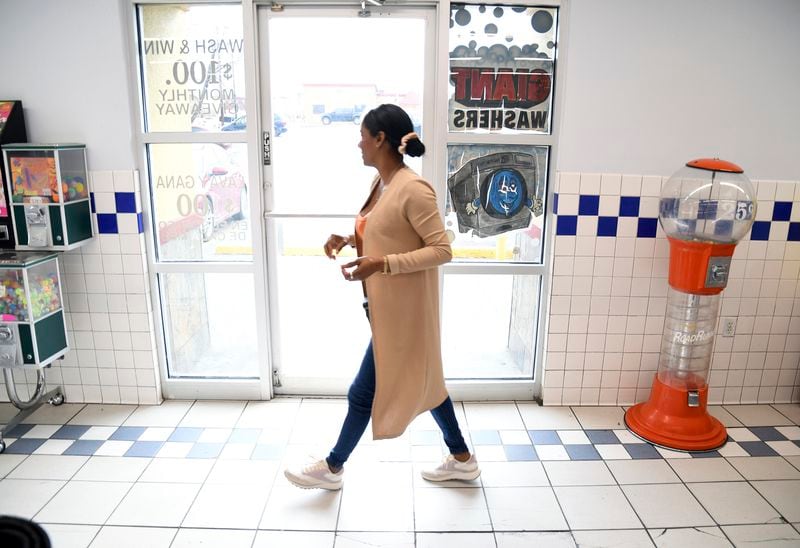 Sofia Roca, an immigrant from Colombia, washes clothes at a laundromat in Aurora, Colorado, on March 29, 2024. (AP Photo/Thomas Peipert)