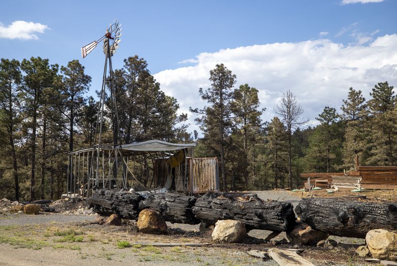 The remains of a business destroyed by the South Fork Fire are pictured in the mountain village of Ruidoso, N.M., Saturday, June 22, 2024. (AP Photo/Andres Leighton)