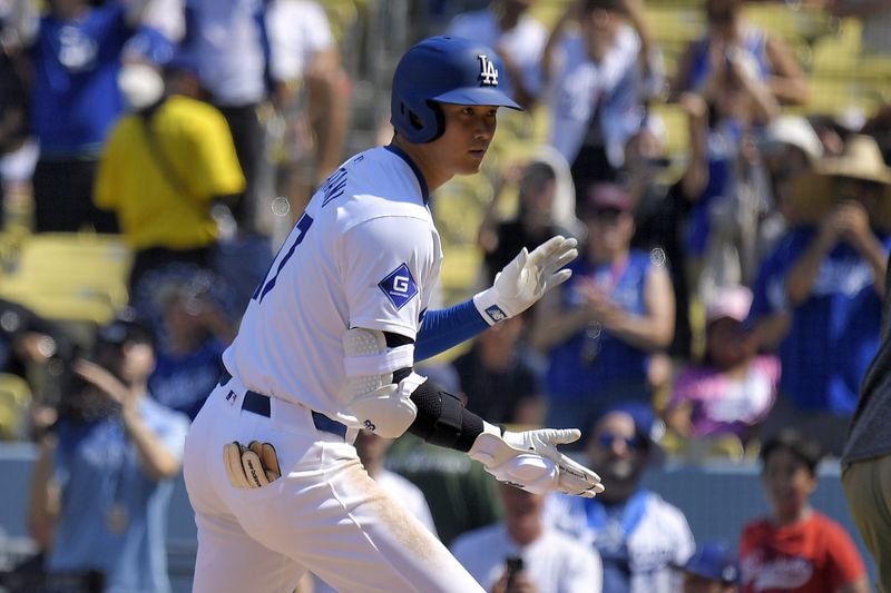 Los Angeles Dodgers' Shohei Ohtani scores after hitting a solo home run during the fifth inning of a baseball game against the Cleveland Guardians, Sunday, Sept. 8, 2024, in Los Angeles. (AP Photo/Mark J. Terrill)