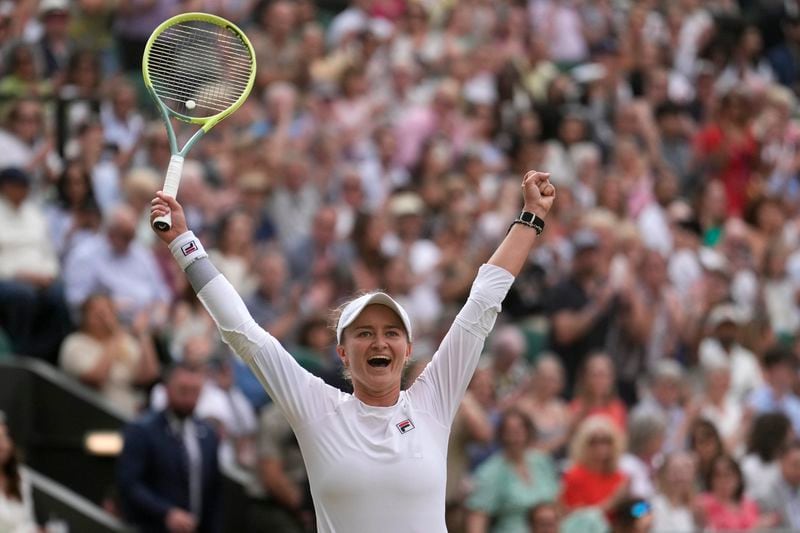 Barbora Krejcikova of the Czech Republic celebrates after defeating Elena Rybakina of Kazakhstan in their semifinal match at the Wimbledon tennis championships in London, Thursday, July 11, 2024. (AP Photo/Mosa'ab Elshamy)