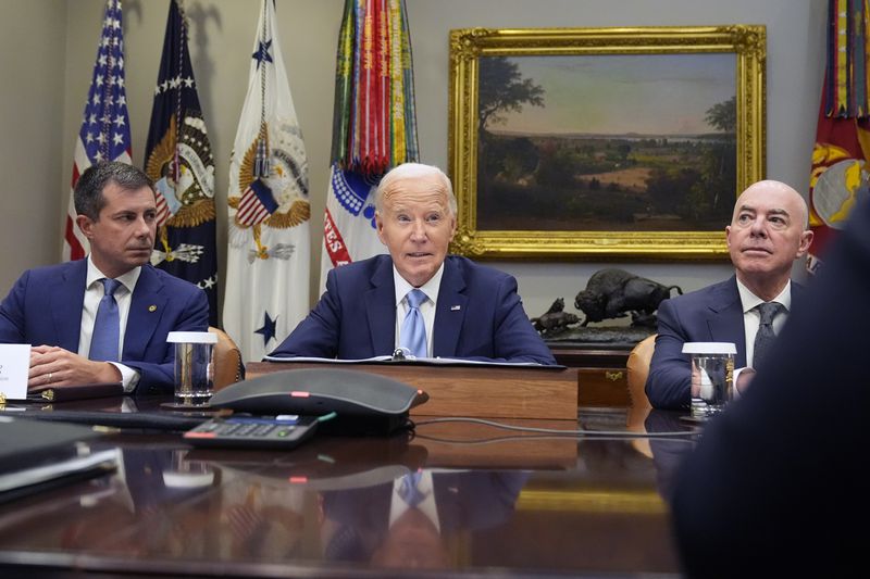 President Joe Biden (center) speaks about the response to Hurricane Helene as Secretary of Transportation Pete Buttigieg (left) and Secretary of Homeland Security Alejandro Mayorkas (right) listen.