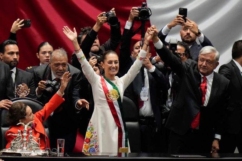 President Claudia Sheinbaum and outgoing President Andres Manuel López Obrador wave on her inauguration day at Congress in Mexico City, Tuesday, Oct. 1, 2024. (AP Photo/Eduardo Verdugo)