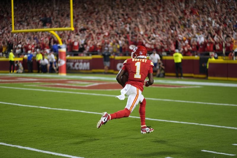 Kansas City Chiefs wide receiver Xavier Worthy heads for the end zone after catching a 35-yard pass for a touchdown during the second half of an NFL football game against the Baltimore Ravens Thursday, Sept. 5, 2024, in Kansas City, Mo. (AP Photo/Charlie Riedel)