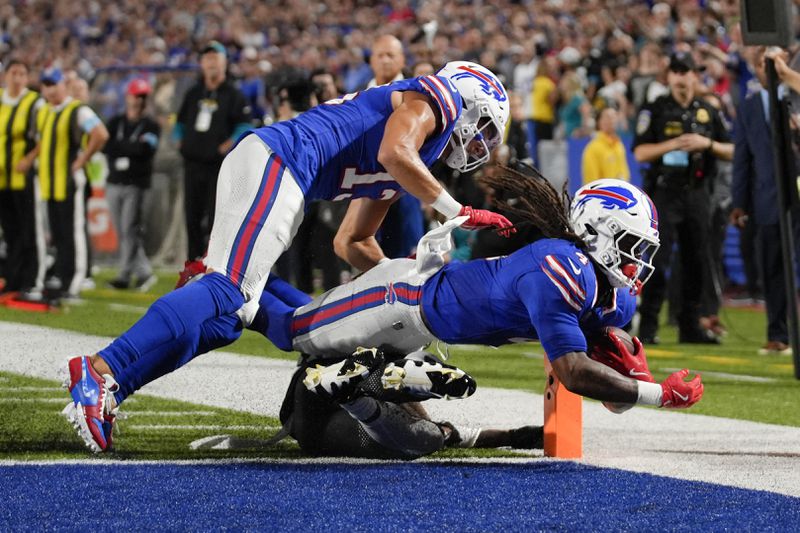 Buffalo Bills running back James Cook (4) lunges into the end zone to score a touchdown during the first half of an NFL football game against the Jacksonville Jaguars, Monday, Sept. 23, 2024, in Orchard Park, NY. (AP Photo/Steven Senne)