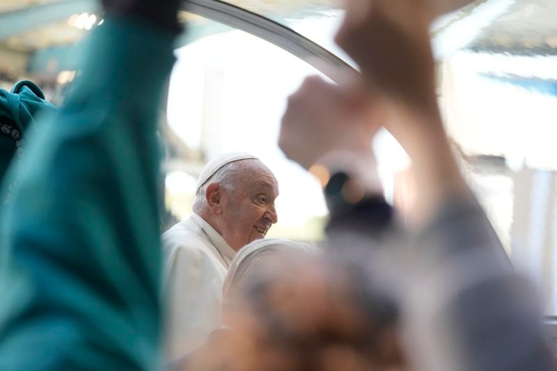 Pope Francis is cheered by faithful as he arrives to preside over the Sunday mass in King Baudouin Stadium, in Brussels Sunday, Sept. 29, 2024. (AP Photo/Andrew Medichini)