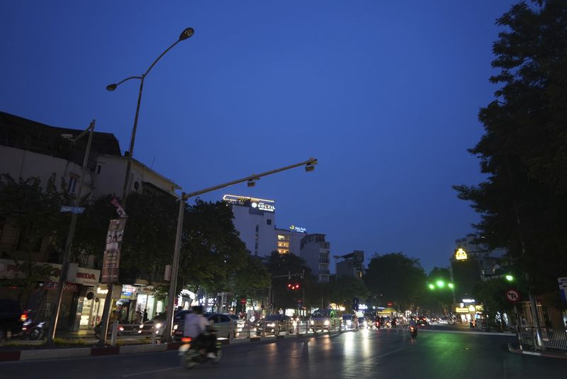 FILE- Road lights are switched off to save energy in Hanoi, on June 8, 2023. (AP Photo/Hau Dinh, File)