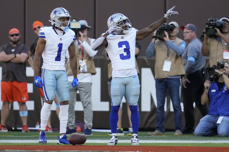 Dallas Cowboys wide receiver Brandin Cooks (3) and Jalen Tolbert (1) celebrate Cook's touchdown catch against the Cleveland Browns in the first half of an NFL football game in Cleveland, Sunday, Sept. 8, 2024. (AP Photo/Sue Ogrocki)