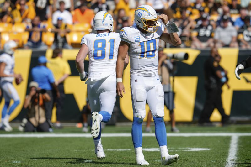 Los Angeles Chargers quarterback Justin Herbert (10) walks off the field after being sacked by Pittsburgh Steelers linebacker Elandon Roberts during the second half of an NFL football game, Sunday, Sept. 22, 2024, in Pittsburgh. (AP Photo/Gene J. Puskar)