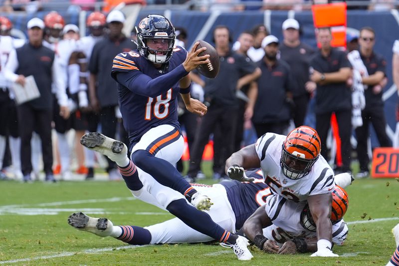 Chicago Bears quarterback Caleb Williams (18) breaks away from a tackle against the Cincinnati Bengals during the first half of an NFL preseason football game, Saturday, Aug. 17, 2024, at Soldier Field in Chicago. (AP Photo/Charles Rex Arbogast)