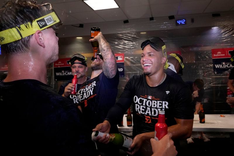 Detroit Tigers' Wenceel Perez, right, celebrates with the team in the clubhouse after defeating the Houston Astros in Game 2 to clinch the AL Wild Card baseball series, Wednesday, Oct. 2, 2024, in Houston. (AP Photo/Kevin M. Cox)