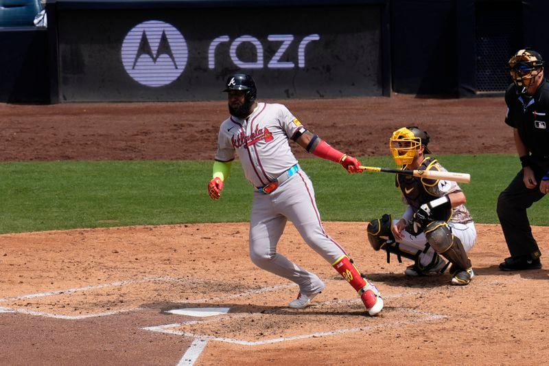 Atlanta Braves' Marcell Ozuna watches his single during the sixth inning of a baseball game against the San Diego Padres, Sunday, July 14, 2024, in San Diego. (AP Photo/Gregory Bull)