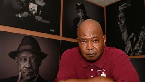 FILE: Photojournalist Johnny Crawford inside his office surrounded by portraits from his Vietnam Black Soldiers Portrait Project and “The Perfect Gift,” The African American Organ Transplantation Project. (Photograph by Joshua Crawford) 

©2022 Johnny Crawford.