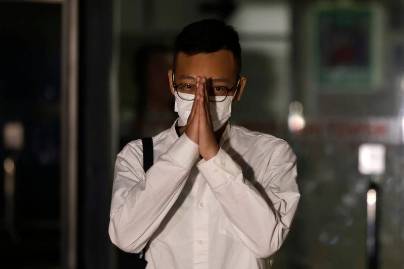 Patrick Lam, the former acting editor-in-chief of Hong Kong's now shuttered pro-democracy news outlet Stand News gestures to the gathered media as he leaves the Wanchai District Court after the final sentencing of Stand News sedition case in Wan Chai district court in Hong Kong on Thursday, Sept. 26, 2024. (AP Photo/May James)