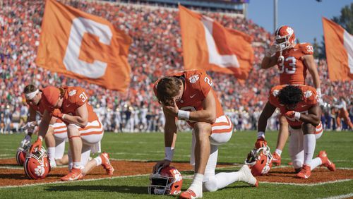 FILE - Clemson quarterback Cade Klubnik (2) takes a knee before an NCAA college football game against Notre Dame, Nov. 4, 2023, in Clemson, S.C. (AP Photo/Jacob Kupferman, File)