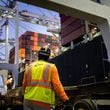 A worker waits for a crane to start moving containers from ship to shore at the Port of Savannah, in Savannah, Ga., Sept. 30, 2021. (Erin Schaff/The New York Times)