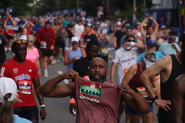 Calvin McAllister celebrates at the finish of the 55th running of the Atlanta Journal-Constitution Peachtree Road Race in Atlanta on Thursday, July 4, 2024.   (Jason Getz / AJC)