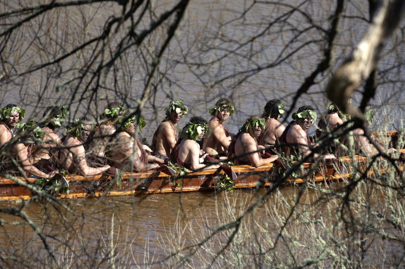 A waka, a traditional canoe, is paddled by warriors on the Waikato River as part of the funeral of New Zealand's Maori King, Kiingi Tuheitia Pootatau Te Wherowhero VII, in Ngaruawahia, New Zealand, Thursday, Sept. 5, 2024. (AP Photo/Alan Gibson)