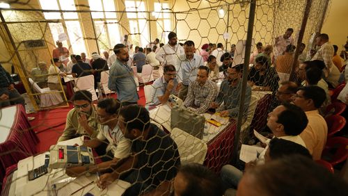 Election officers count votes for the recent election at a counting center in Jammu, India, Tuesday, Oct. 8, 2024. (AP Photo/Channi Anand)