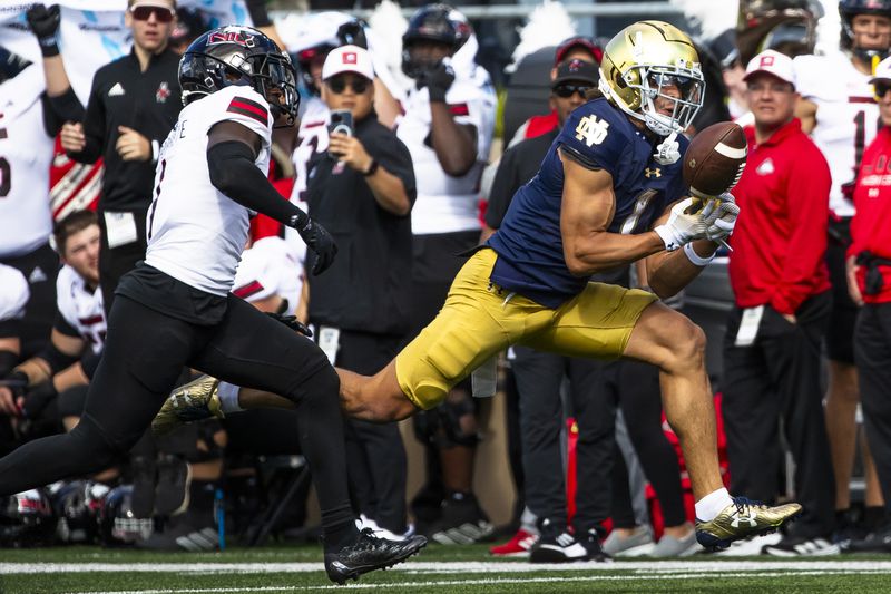 Notre Dame wide receiver Jaden Greathouse, right, cannot hold onto a pass as Northern Illinois defensive back Jashon Prophete, left, pursues during an NCAA college football game Saturday, Sept. 7, 2024, in South Bend, Ind. (AP Photo/Michael Caterina)