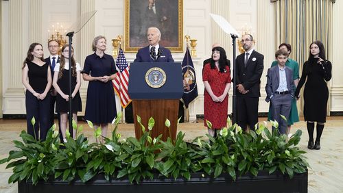 President Joe Biden, center, delivers remarks on a prisoner swap with Russia from the State Dining Room of the White House, Thursday, Aug. 1, 2024, in Washington. (AP Photo/Evan Vucci)