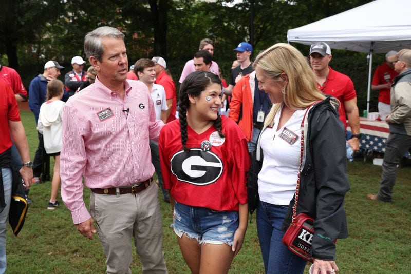 Governor Brian Kemp and his wife Marty, right, talk with UGA senior Stephanie Reyes, center, after she got a photograph with the Kemps at Herty Field before the Georgia football team hosted Samford, Saturday, September 10, 2022, in Athens. (Jason Getz / Jason.Getz@ajc.com)