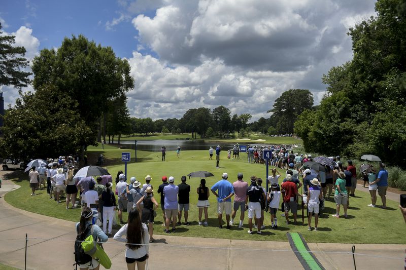 Spectators watch as players tee off from the fourth hole during the final round of the KPMG Women’s PGA Championship Sunday, June 27, 2021, at the Atlanta Athletic Club in Johns Creek. (Daniel Varnado/For the AJC)