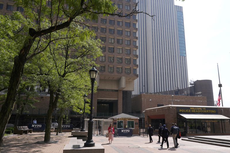 People walk past One Police Plaza, the headquarters of the New York City Police Department, Thursday, Sept. 12, 2024, in New York. (AP Photo/Pamela Smith)