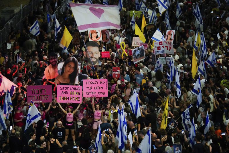 People protest against Prime Minister Benjamin Netanyahu's government and call for the release of hostages held in the Gaza Strip by the Hamas militant group, in Tel Aviv, Israel, Saturday, Sept. 7, 2024. (AP Photo/Ariel Schalit)