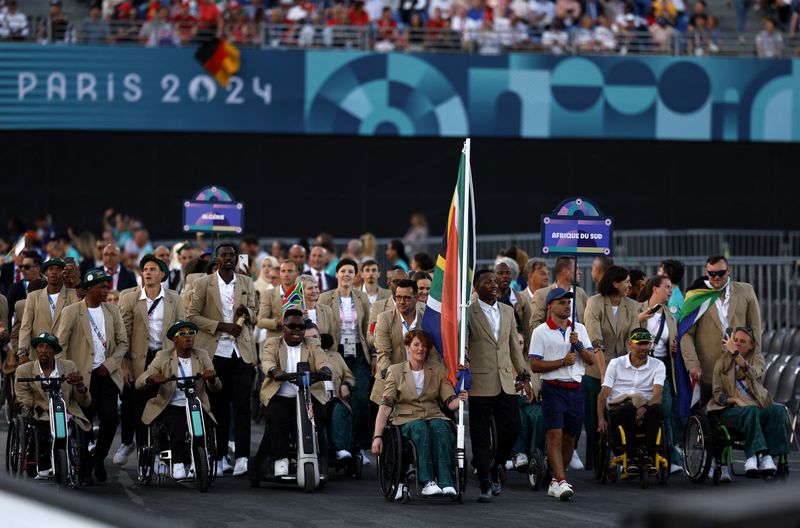 Flagbearers Mpumelelo Mhlongo of South Africa and Kat Swanepoel of South Africa lead their contingent during the Opening Ceremony for the 2024 Paralympics, Wednesday, Aug. 28, 2024, in Paris, France. (Gonzalo Fuentes/Pool Photo via AP)