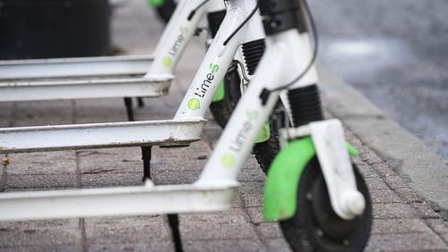 01/04/2019 — Atlanta, Georgia — Lime Scooters sit parked on Peachtree Street in Atlanta’s Midtown community, Friday, January 4, 2019. (ALYSSA POINTER/ALYSSA.POINTER@AJC.COM)