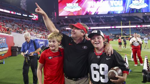 Georgia head coach Kirby Smart, center, celebrates with son Andrew, left, and another person after Georgia’s 43-20 win against Florida at EverBank Stadium, Saturday, Oct. 27, 2023, in Jacksonville, Fl. (Jason Getz / Jason.Getz@ajc.com)