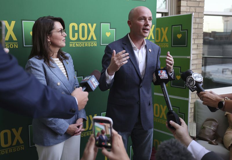 Gov. Spencer Cox and Lt. Gov. Deidre Henderson talk with media during a primary election night party in Salt Lake City, Tuesday, June 25, 2024. (Jeffrey D. Allred/The Deseret News via AP)