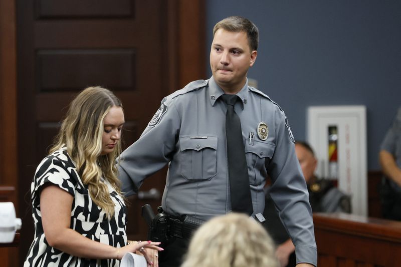 Villa Rica police Officer Chase Gordy (right) leaves the stand after providing his victim impact statement at the sentencing hearing for Aaron Shelton. 