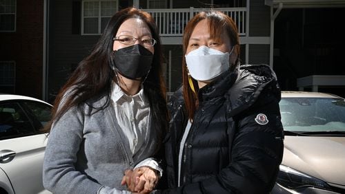 Hyo Jung Kim, 46, (left) and Hyun Jung Kim, 48, are the daughters of the late Soon Chung Park, one of the Atlanta spa shooting victims. Their mother’s apartment unit is shown in background in Duluth on Friday, April 2, 2021. Soon Chung Park was among eight people shot and killed March 16 at three spas — two in Atlanta and one in Cherokee County. Park was one of six female victims of Asian heritage. (Hyosub Shin / Hyosub.Shin@ajc.com)