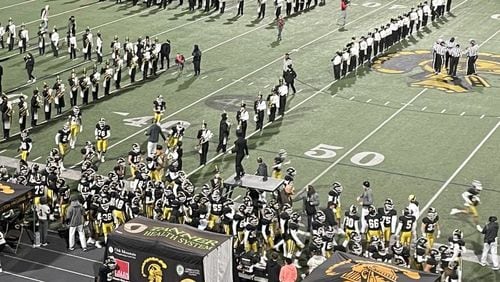 Carrollton players take the field before their Class 6A quarterfinal game on Nov. 26, 2021, at Grisham Stadium in Carrollton. The Trojans defeated Westlake 37-32.