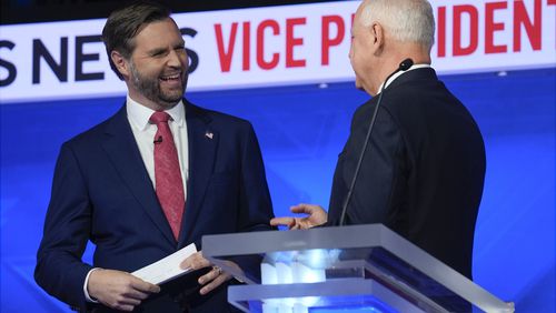 Republican vice presidential nominee Sen. JD Vance, R-Ohio, talks with Democratic vice presidential candidate Minnesota Gov. Tim Walz after the vice presidential debate hosted by CBS News Tuesday, Oct. 1, 2024, in New York. (AP Photo/Matt Rourke)