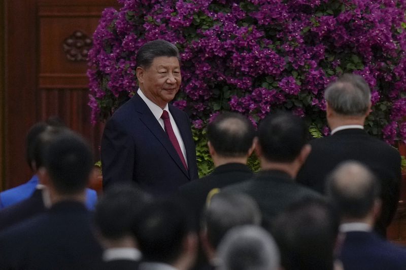 Leaders and invited guests stand as Chinese President Xi Jinping arrives for a dinner marking the 75th anniversary of the founding of the People's Republic of China, at the Great Hall of the People in Beijing, Monday, Sept. 30, 2024. (AP Photo/Andy Wong)