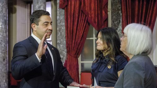 Sen. Patty Murray, D-Wash., right, administers the oath of office to Sen. George Helmy, D-N.J., left, as his wife Caroline Helmy holds the Bible during a re-enactment swearing-in, in the Old Senate Chamber at the Capitol in Washington, Monday, Sept. 9, 2024. (AP Photo/Rod Lamkey, Jr.)